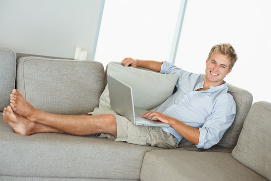 man-with-a-laptop-on-a-couch