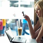 woman-with-laptop-and-phone-in-cafe