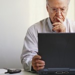 Pensive Businessman Using Laptop