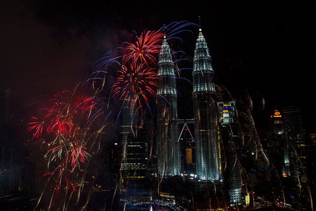 Fireworks explode near the landmark Petronas Towers