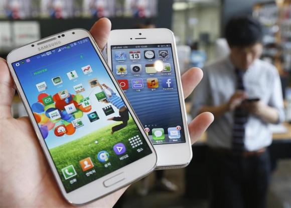 File picture illustration of Samsung Electronics' Galaxy S4 and Apple's iPhone 5 taken in Seoul