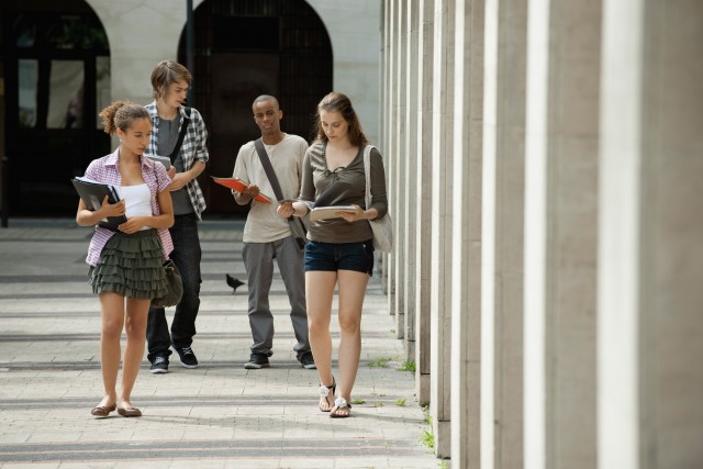 University students walking on campus discussing schoolwork