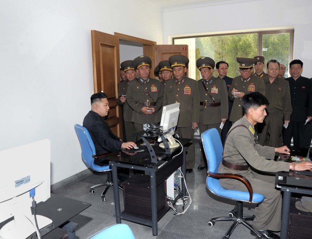 North Korean leader Kim looks at a computer screen as he visits Air and Anti-air Force Command of the Korean People's Army in this picture released by the North's official KCNA news agency in Pyongyang