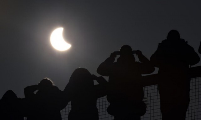 The eclipse begins over the Eden Project near St Austell, England