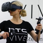 A woman checks a pair of Vive Virtual Reality goggles, produced by Taiwan's HTC, during the Gamescom 2015 fair in Cologne, Germany August 5, 2015. The Gamescom convention, Europe's largest video games trade fair, runs from August 5 to August 9. REUTERS/Kai Pfaffenbach  - RTX1N5FQ