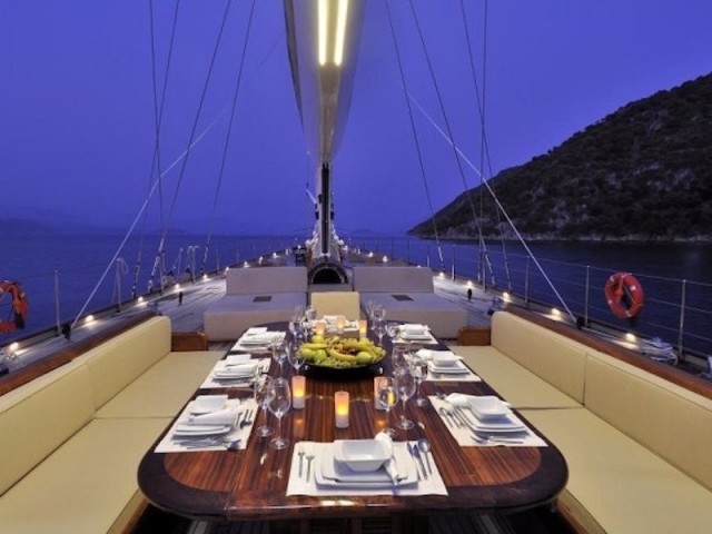 a-table-on-the-deck-also-has-room-for-all-the-guests-on-board