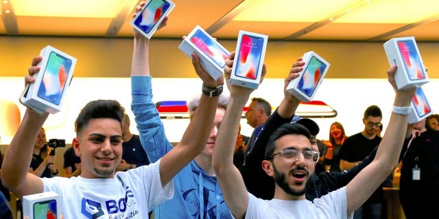 The first customers to buy the iPhone X react during global launch of the new Apple product in central Sydney
