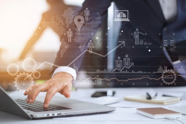 Businessman working using laptop computer with strategy and growth of business on screen