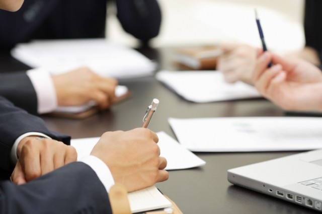 Businessmen having meeting, view of hands