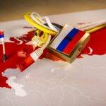 Padlock, net cable, Russia flag on a smartphone and Russia map.