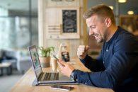 happy-freelancer-with-tablet-laptop-computer-coffee-shop